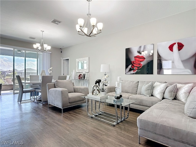 living room featuring visible vents, a chandelier, and wood finished floors