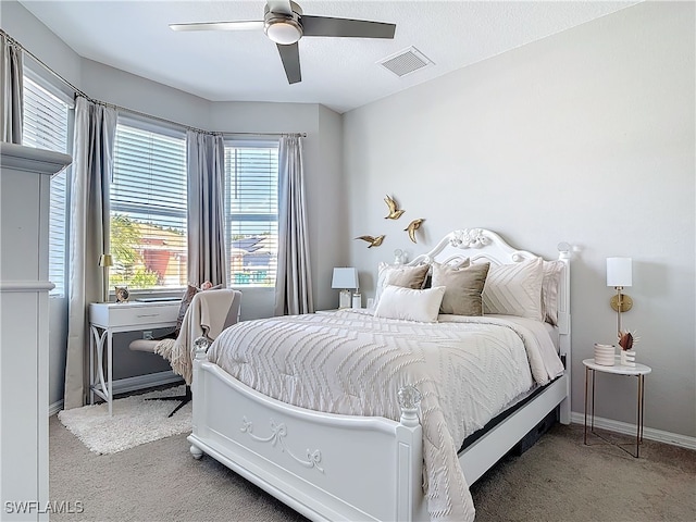 bedroom featuring a ceiling fan, carpet, visible vents, and baseboards