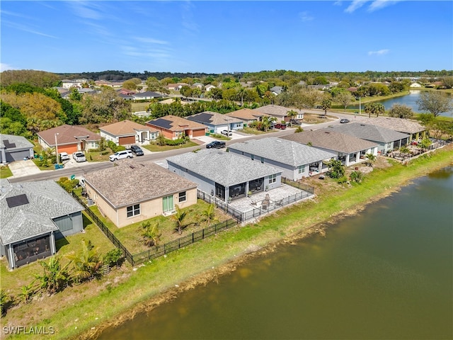 drone / aerial view featuring a water view and a residential view