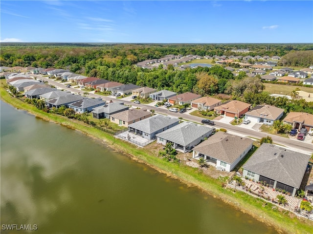 drone / aerial view featuring a water view and a residential view