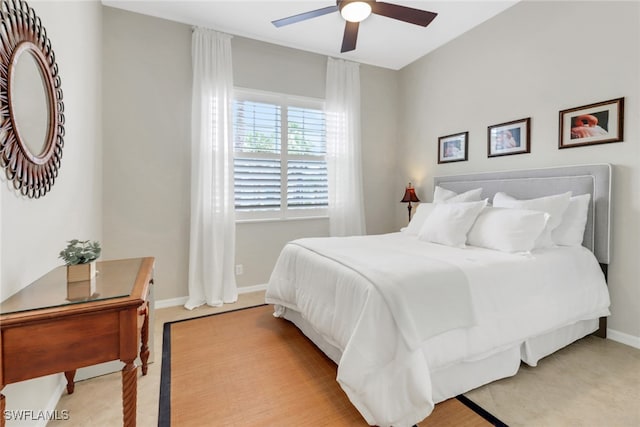 bedroom with a ceiling fan and baseboards