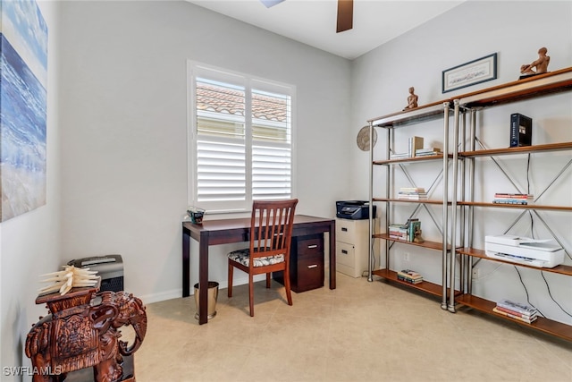 office area with ceiling fan and baseboards