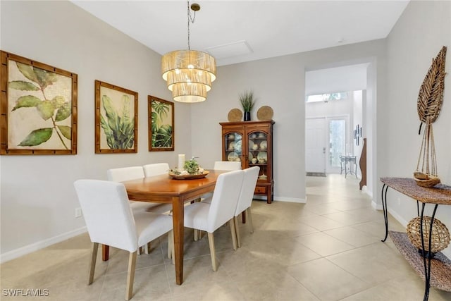 dining room with a notable chandelier, baseboards, and light tile patterned floors