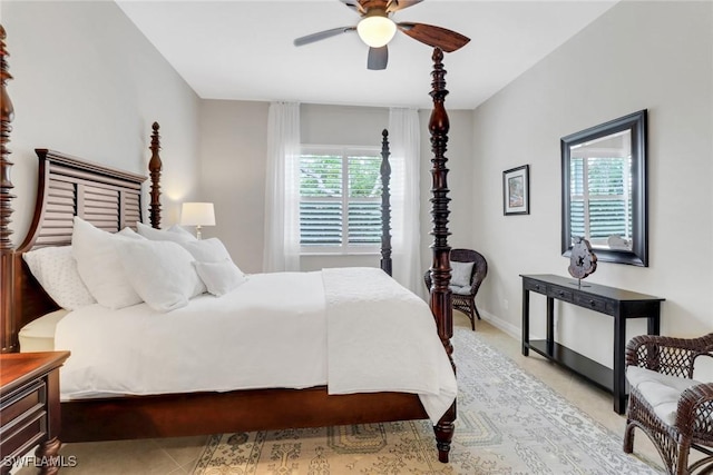 bedroom featuring light tile patterned floors, ceiling fan, and baseboards