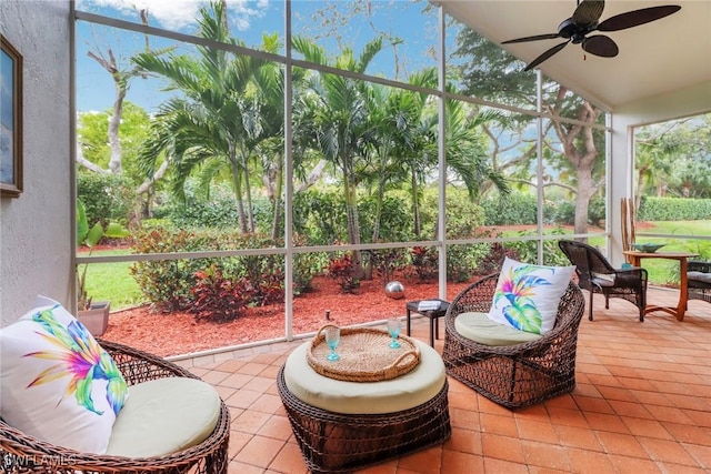 sunroom featuring vaulted ceiling, plenty of natural light, and a ceiling fan