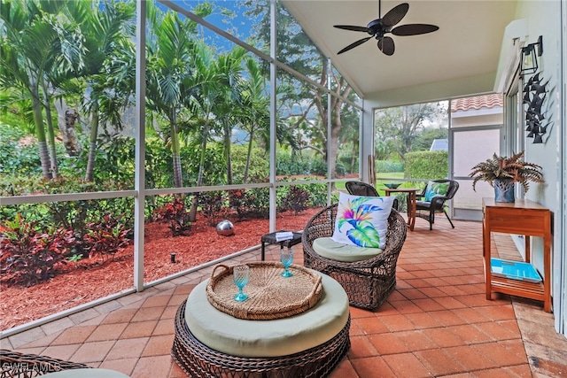 sunroom / solarium with ceiling fan and vaulted ceiling