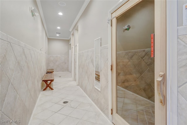 hall featuring light tile patterned floors, ornamental molding, tile walls, and recessed lighting