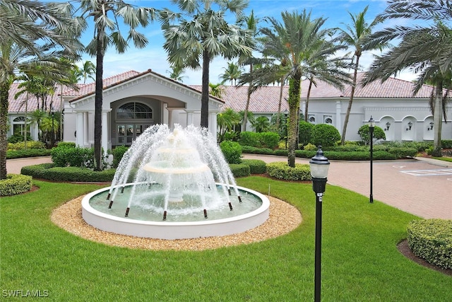 view of property's community with a lawn