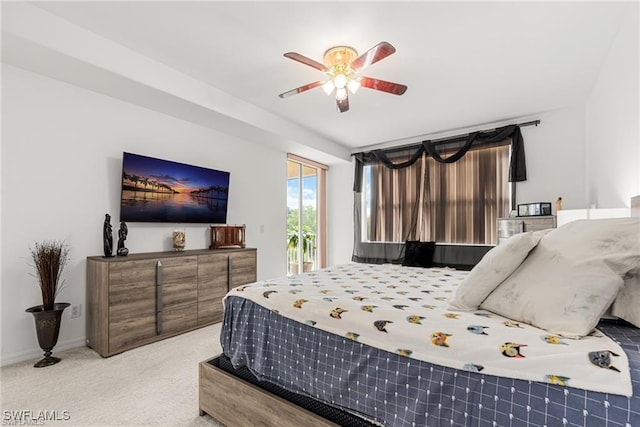 carpeted bedroom featuring access to outside, a ceiling fan, and baseboards