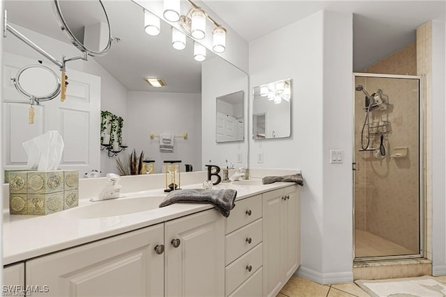 full bath with double vanity, a stall shower, tile patterned flooring, and a sink