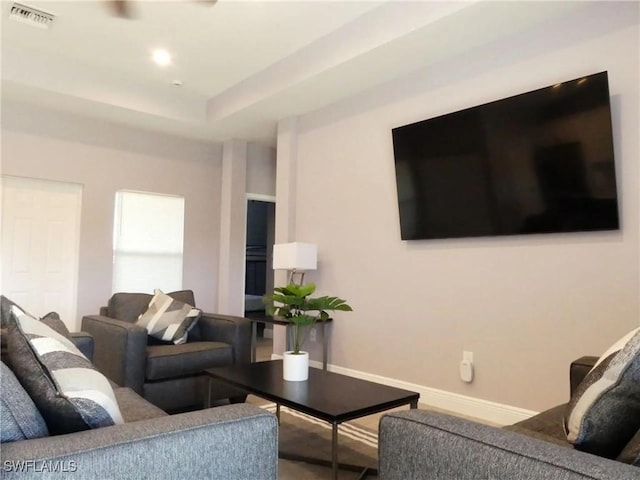 living area with visible vents and baseboards