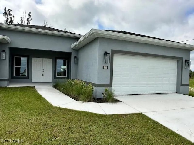 view of front of house with a garage, a front lawn, concrete driveway, and stucco siding