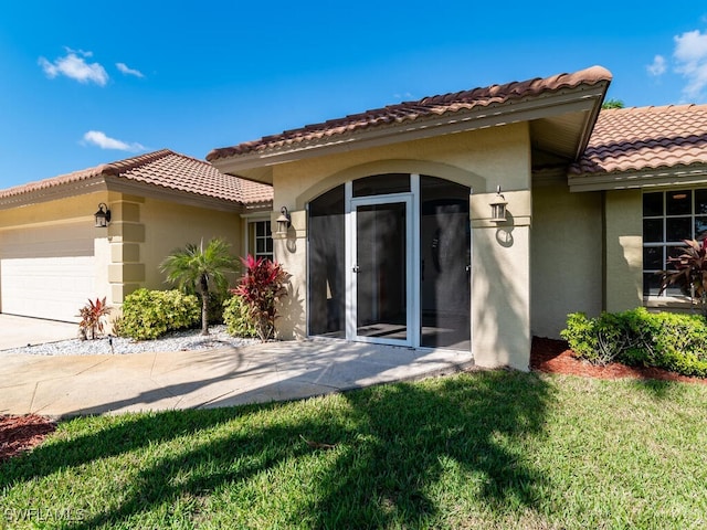 exterior space featuring an attached garage, a tile roof, concrete driveway, a lawn, and stucco siding