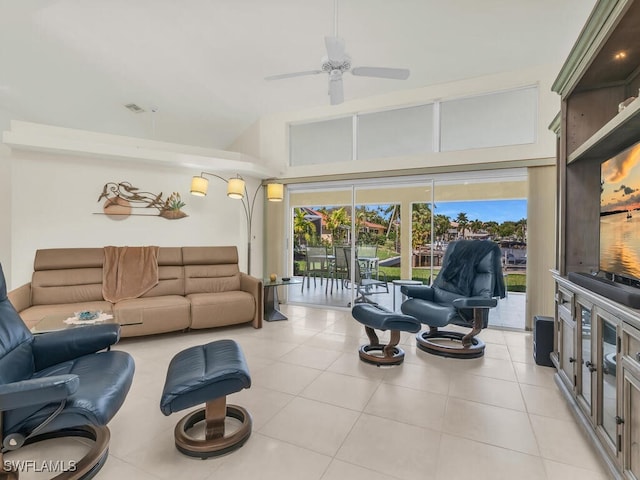 living room with light tile patterned floors, a high ceiling, and a ceiling fan