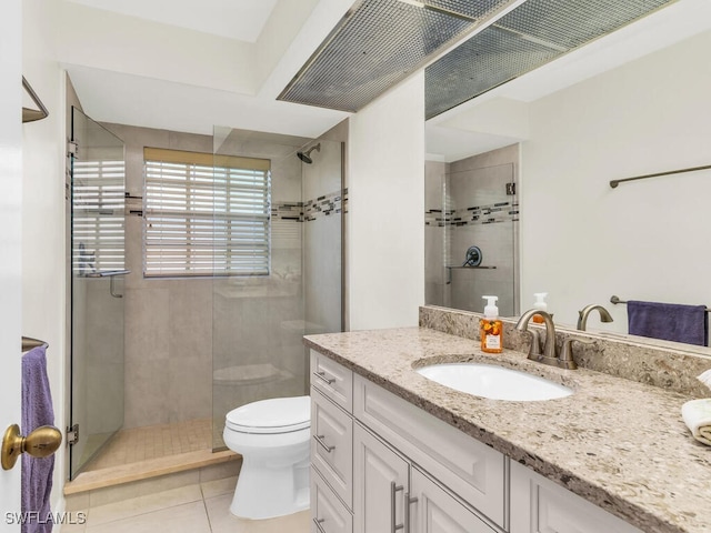 full bath with a stall shower, vanity, toilet, and tile patterned floors