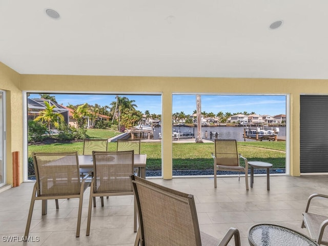 sunroom / solarium with a water view