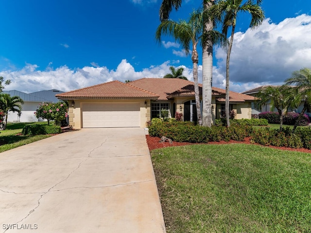 view of front facade with driveway, stucco siding, a tiled roof, an attached garage, and a front yard