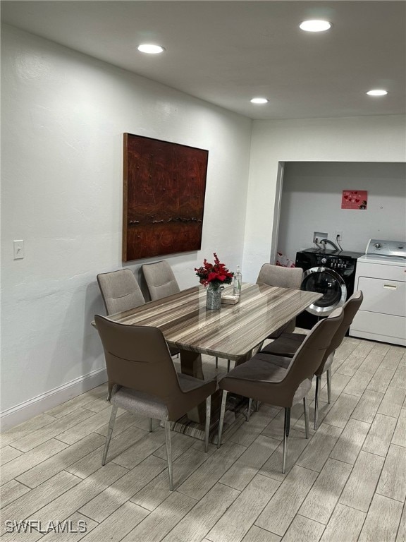 dining space with wood tiled floor, baseboards, washer and clothes dryer, and recessed lighting