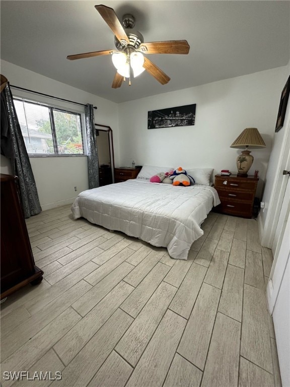 bedroom featuring ceiling fan and wood finish floors