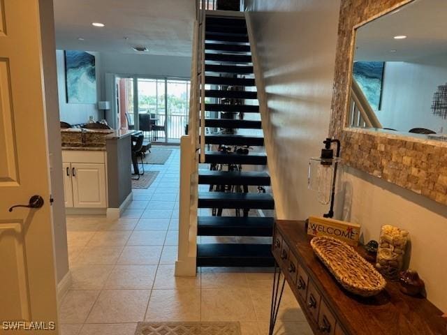 stairway with tile patterned flooring and recessed lighting