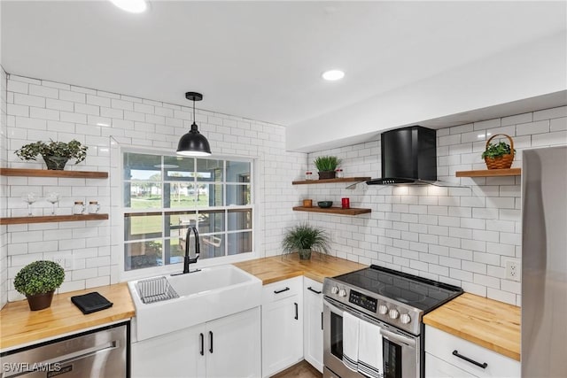 kitchen with stainless steel appliances, butcher block countertops, and open shelves