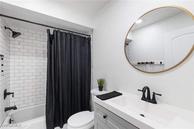 full bath featuring toilet, shower / bath combo with shower curtain, and vanity