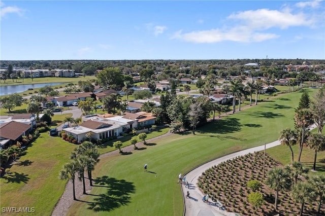 birds eye view of property with view of golf course and a water view