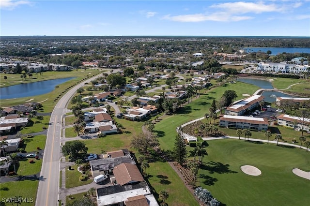 drone / aerial view featuring view of golf course and a water view