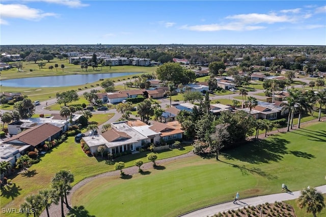 drone / aerial view with golf course view, a water view, and a residential view