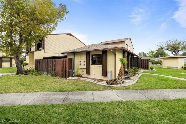 1212 SE 6th Ter Unit 83, Cape Coral, FL 33990 - view of front facade with stucco siding, central air condition unit, and roof with shingles