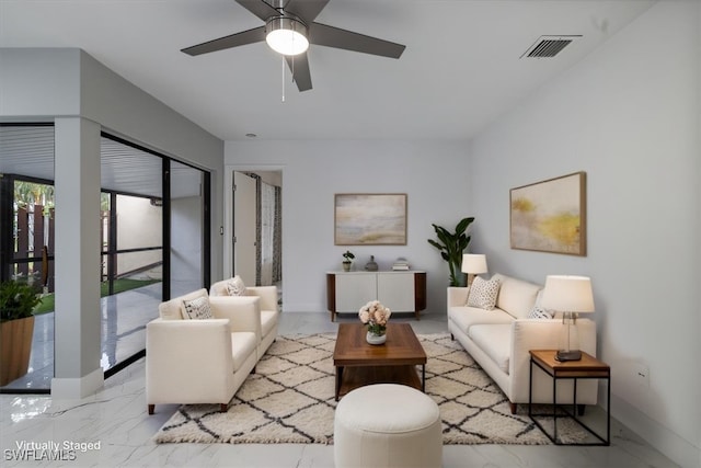 1212 SE 6th Ter Unit 83, Cape Coral, FL 33990 - living room featuring light marble finish floors, ceiling fan, and baseboards