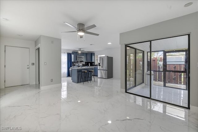 1212 SE 6th Ter Unit 83, Cape Coral, FL 33990 - unfurnished living room featuring ceiling fan, light marble finish flooring, and baseboards