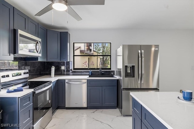1212 SE 6th Ter Unit 83, Cape Coral, FL 33990 - kitchen featuring appliances with stainless steel finishes, a sink, ceiling fan, light countertops, and light marble finish flooring