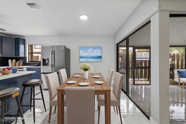 1212 SE 6th Ter Unit 83, Cape Coral, FL 33990 - dining room featuring light marble finish flooring