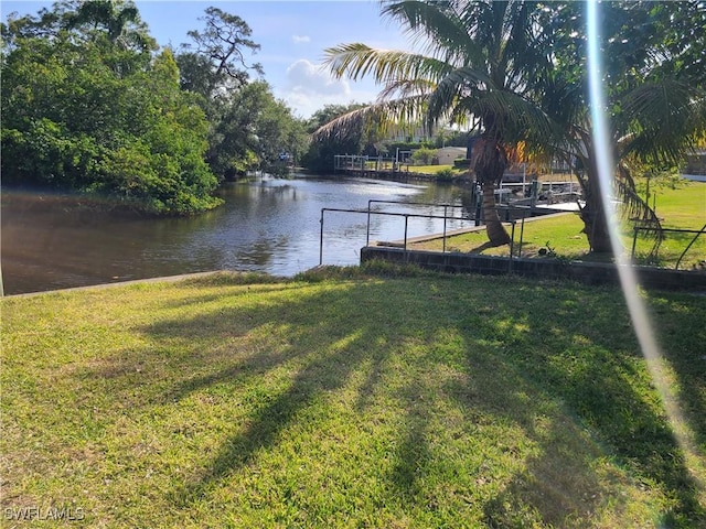 27253 Rio Vista Cir, Bonita Springs, FL 34135 - view of dock featuring a lawn and a water view