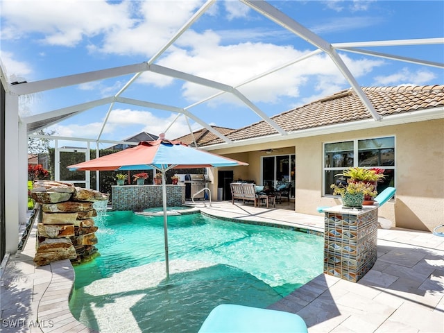 view of pool with a patio area, a grill, and a pool with connected hot tub