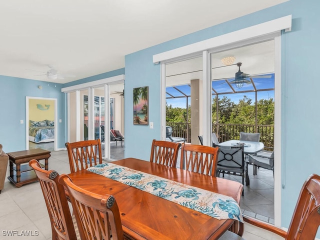 dining space with a ceiling fan, a sunroom, and light tile patterned floors