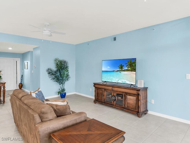 living room with visible vents, baseboards, and light tile patterned floors