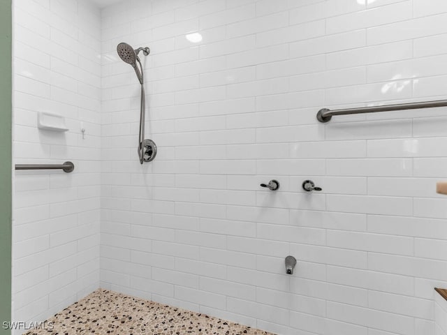 bathroom with tiled shower