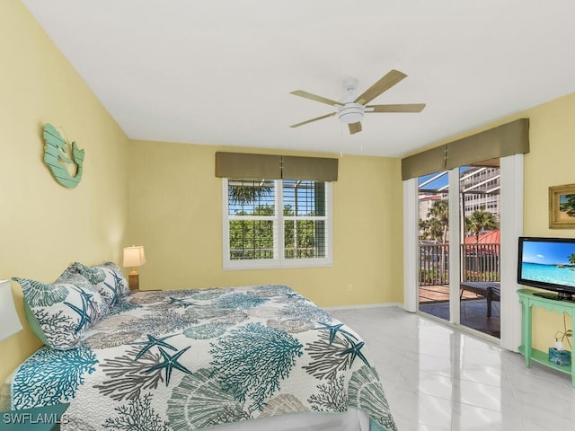 bedroom with access to exterior, ceiling fan, and baseboards