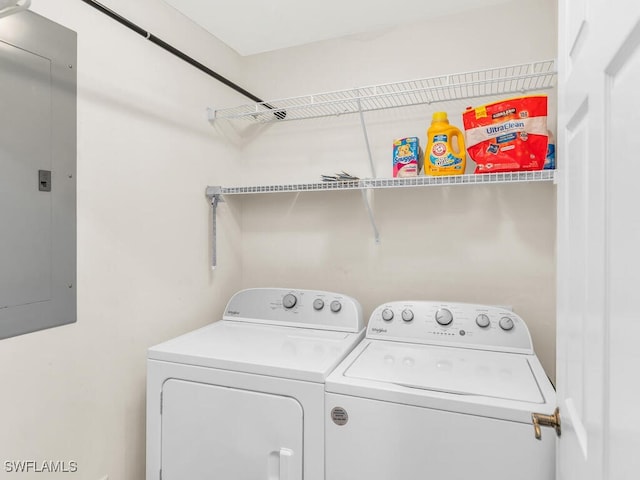 clothes washing area with laundry area, electric panel, and independent washer and dryer