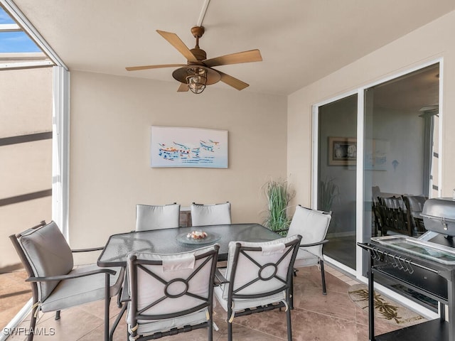 interior space featuring a ceiling fan and light tile patterned floors