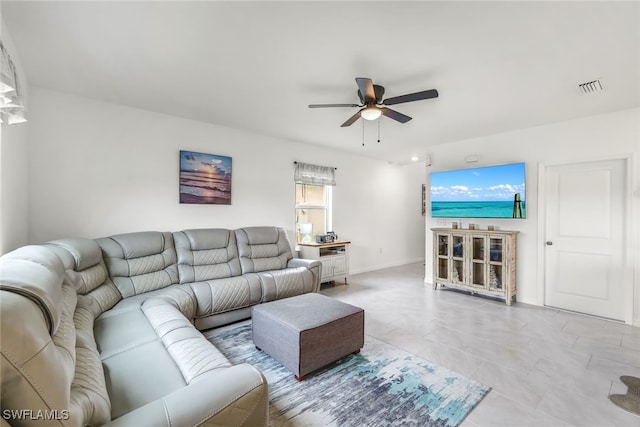 living area featuring visible vents and ceiling fan