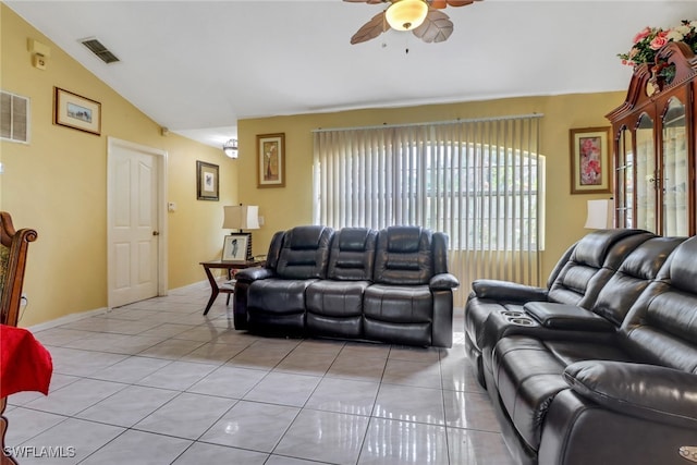 living area with lofted ceiling, ceiling fan, light tile patterned flooring, visible vents, and baseboards