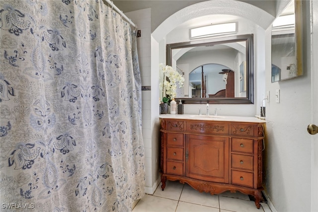 full bathroom featuring a stall shower, tile patterned flooring, and vanity