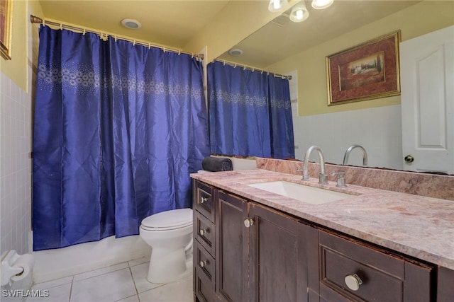 bathroom featuring tile patterned flooring, shower / tub combo with curtain, vanity, and toilet