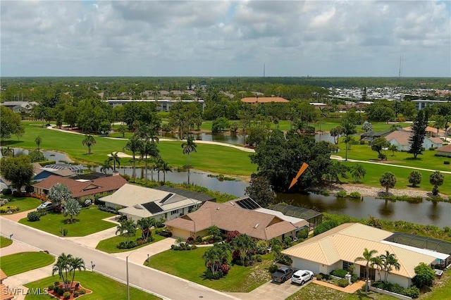 aerial view with view of golf course, a water view, and a residential view