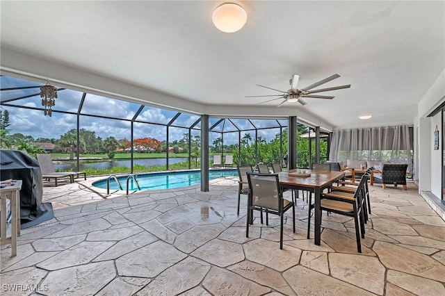 sunroom featuring ceiling fan, a swimming pool, and a water view