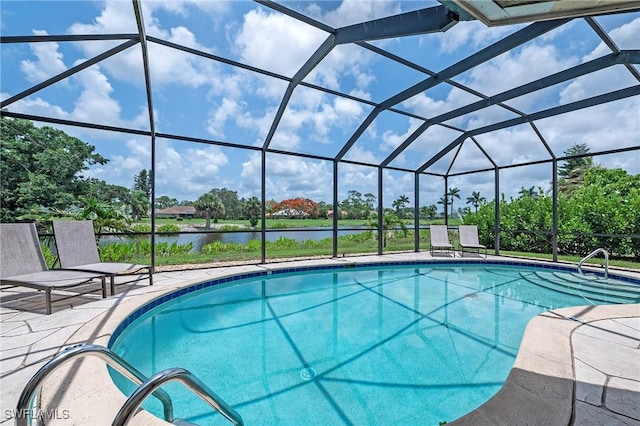 pool featuring glass enclosure, a patio, and a water view