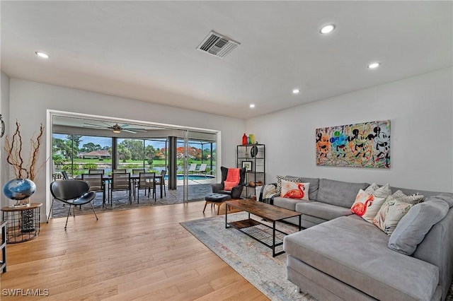 living area featuring light wood-type flooring, ceiling fan, visible vents, and recessed lighting